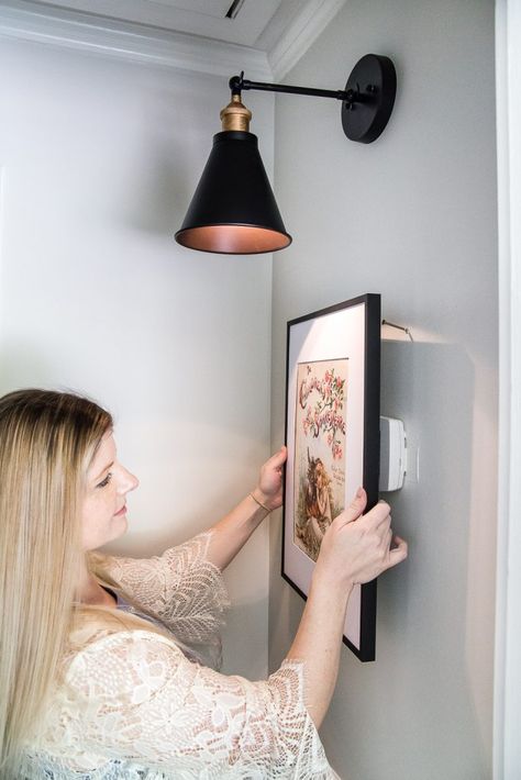 Simple Thermostat Cover and Hallway Progress | A dark, beige hallway gets a light and bright makeover, plus a solution for creating an inexpensive thermostat cover and sconce lighting without the electrical work. #thermostatcover #hallway #hallwaymakeover #beforeandafter #sconce #sconcelight #walldecor #wallart #budgetdecor #freeart #decortrick #eyesorecover Simple Thermostat Cover Beige Hallway, Affordable Apartment Decor, Thermostat Cover, Hallway Makeover, Hiding Ugly, Vanity Makeover, Farmhouse Side Table, Room Tips, Shower Design