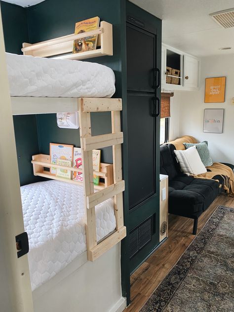 Bunkroom. Camper ladder. Camper bunk remodel. Dark paint color. Green walls. Diy Camper Bunk Ladder, Camper Cabinet Color Ideas, Rv Ladders For Bunks, Camper Bunk Remodel, Green Interior Camper, Travel Trailer Bunk Beds Ideas, Dark Green Camper Interior, Rv Bunk Ladder Diy, Green Caravan Interior