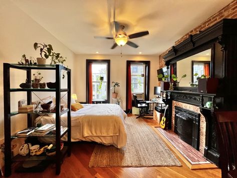 Studio apartment in Brooklyn with huge ornate glossy black wood fireplace surround. Ikea Hacks For Cats, My Studio Apartment, Wood Fireplace Surrounds, Toy Storage Bench, Ikea Eket, Black Fireplace, Tiny Studio, Doll Beds, Black Fire