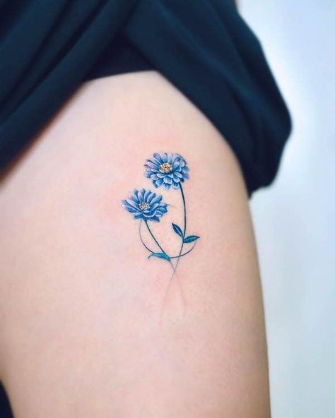 Marigold October birth flower tattoo by @haenytattoo Blue Aster Flower, October Birth Flower Tattoo, Wrap Around Ankle Tattoos, Hummingbird Flower Tattoos, Aster Flower Tattoos, Flower Foot Tattoo, Honeysuckle Tattoo, Marigold Tattoo, Cosmos Tattoo