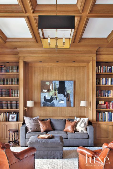 The rear façade shows off the exterior’s classic East Coast vibe. A covered terrace houses a teak dining table and chairs from Adams Furniture in High Point, North Carolina, and Kingsley-Bate head chairs. Custom bifolding Marvin doors from Goldfinch Brothers open to connect the indoors and outdoors. Transitional Library, Paneled Library, Cozy Library, Oak Panels, Teak Dining Table, Rustic Contemporary, Luxe Interiors, Interior Design Magazine, Interiors Design