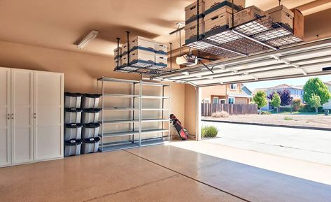 Garage with storage cabinets and overhead ceiling racks Garage Storage Plans, Garage Ceiling Storage, Casa Garage, Garage Storage Inspiration, Storage Hacks Diy, Garage Diy, Garage Storage Ideas, Overhead Garage Storage, Garage Storage Shelves