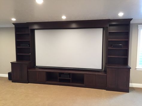 Dark brown shaker style entertainment center with bookcases and space for a tv or projector screen. Diy Entertainment Center Ideas, Entertainment Center Ideas, Projector Screen Diy, Deco Tv, Barn Door Entertainment Center, Wall Screen, Diy Entertainment, Screen Wall, Entertainment Center Makeover