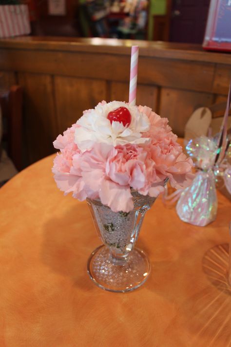 Ice cream sundae centerpieces made with carnations in a sundae glass with a straw and cherry! Ice Cream Sundae Centerpiece, Sundae Glasses Crafts, Ice Cream Sundae Flower Arrangement, Ice Cream Centerpiece Ideas, Ice Cream Cone Flower Arrangements, Ice Cream Party Flower Centerpieces, Sprinkle Flower Vases, Blue Flower Centerpieces, Faux Ice Cream Sundae