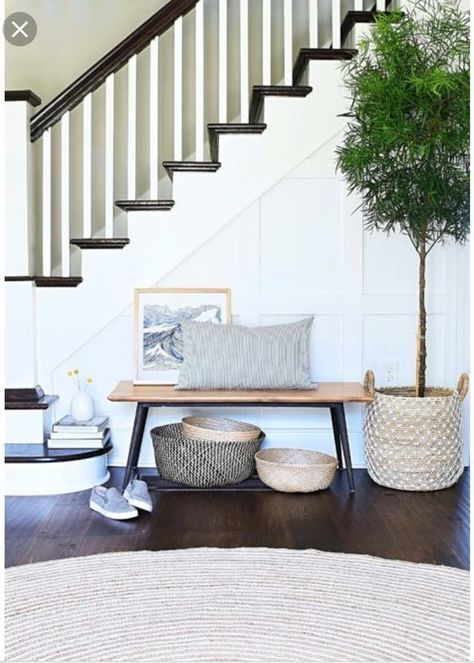 Small bench with round rug and greenery Entryway Bench Under Stairs, Wall In Front Of Stairs Decor, Small Entry Stairs, Front Of Stairs Decor, Entryway Stairs Decor Front Entry, Bench By Stairs, Mud Cupboard, Stairs In Foyer, Bench Under Stairs