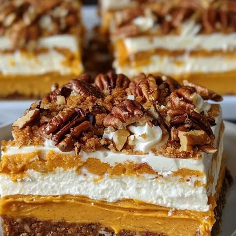 Layered pumpkin cheesecake bars are a delicious fall treat that combines the rich creaminess of cheesecake with the warm flavors of pumpkin pie. Perfect for gatherings ... More information... Layered Pumpkin Cheesecake Bars, Pumpkin Praline Cheesecake, Pumpkin Pie Cheesecake Bars, Layered Pumpkin Cheesecake, Pumpkin Cheesecake Bars, Pumpkin Pie Cheesecake, Pie Cheesecake, Layered Desserts, Cake Bars