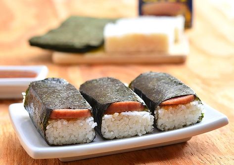 Spam Musubi- a popular Hawaiian snack, a slice of spam is cooked in soy sauce and laid over a rectangular block of short grain rice then wrapped in nori seaweed for an island take on traditional sushi Spam Sushi, Spam Musubi Recipe, Musubi Recipe, Hawaiian Snacks, Kawaling Pinoy, Sushi Style, Spam Recipes, Sushi Roll Recipes, Spam Musubi