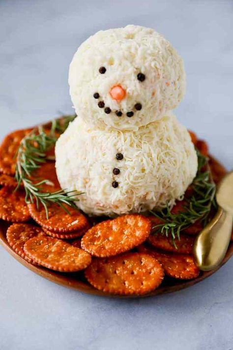 The Best 50 Christmas Appetizers » Lady Decluttered Snowman Cream Cheese Ball, Best Christmas Appetizers Holidays, Christmas Themed Cheese Ball, Christmas Snowman Charcuterie Board, Snowflake Appetizers, Xmas Cheese Ball, Snow Man Cheese Ball Recipes, Cute Christmas Food Ideas Appetizer Recipes, Cheese Ball Presentation