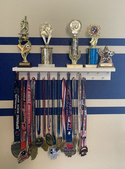 Sports Trophy Display Ideas, Football Medal Display Ideas, Displaying Medals Ideas, Ribbon And Trophy Display Ideas, Soccer Trophy Display Ideas, Trophies Display Ideas, Sports Metal Display Ideas, Award Display Wall Trophy Shelf, Medal Trophy Display Ideas