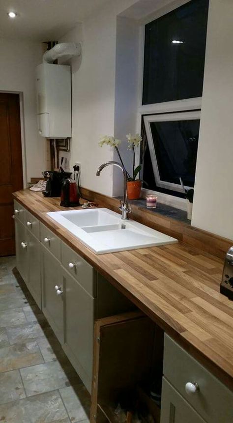 Classic modern kitchen; wood worktop, stone floor, gray green units, oak island porcerlain sink Kitchen Wood Worktop, Kitchen Howdens, Wood Worktop, Laminate Worktop, Laminate Kitchen, Stone Floor, Kitchen Wood, Green Cabinets, Oak Island