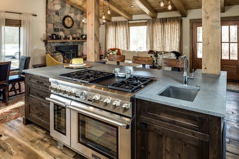 Stove In Center Island, Kitchens With Island Stoves, Rustic Kitchen Island With Stove, Slide In Stove Kitchen Island, Rustic Kitchen Island With Sink, Kitchen Islands With Ranges, Kitchen Island Appliances, Kitchen Island With Stove And Sink, Gas Stove In Island