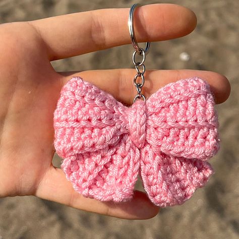 Cute Crochet Pink Coquette Bow Keychain Each toy is handmade by me and made to order. ✅SHIPPING Fast shipping - It will take 1-5 business days to print and ship 🚀 💚Each product is packed and shipped to you with lot of love and care 🧶Acrylic ✅SIZE Approx 5 cm width. ✅CARE INSTRUCTIONS - Wash by hand only. Soak in warm, soapy water without scrubbing. Allow to air dry. Avoid machine washing. - Do not bleach or iron. ✨Thank you so much for visiting my shop! If you have any questions, please feel Cute Crochet Things To Sell, Crochet Bag Decoration, How To Crochet A Keychain, Tiny Things To Crochet, Crochet Bow Keychain, Crochet Keychain Cute, Crochet Bag Keychain, Matching Crochet Keychains, Crochet Party Favors