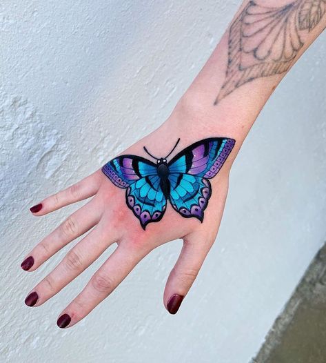 Vibrant Butterfly Tattoo, Butterfly Tattoo Neo Traditional, Hand Tattoo Girl, Neo Traditional Butterfly, Hand Tatts, Auto Tattoo, Vibrant Tattoos, Traditional Butterfly Tattoo, Purple Butterfly Tattoo