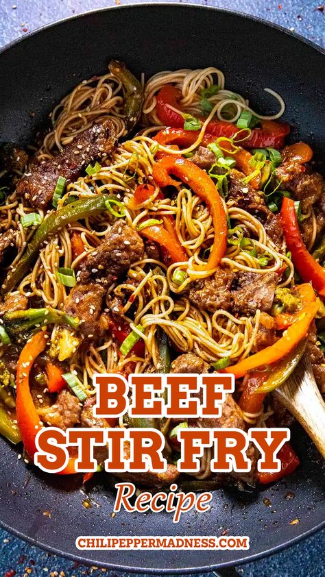 Beef Stir Fry served hot in a pan with a wooden spoon inside the stir fry