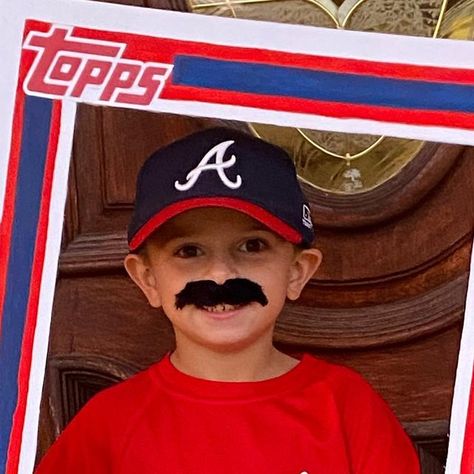 A young Braves fan wears a fake mustache and Braves cap while standing inside a homemade photo frame made to look like a Spencer Strider baseball card. Baseball Card Halloween Costume, Baseball Card Costume, Baseball Team Halloween Costume Ideas, Card Halloween Costume, Team Halloween Costumes, Spencer Strider, Baseball Halloween, Card Costume, Brave Kids