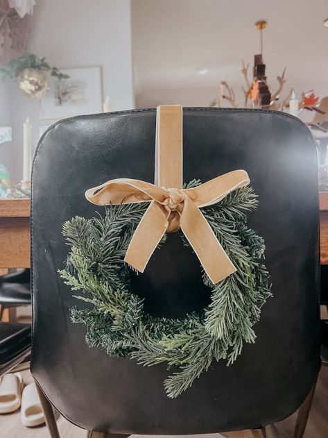 DIY Mini Chair Wreaths for Christmas – Love & Renovations Christmas Bows On Chairs, Wreaths On Bar Stools, Wreaths On Chairs Christmas Decor, How To Tie Ribbon On Wreath, Bar Stool Wreaths, Christmas Wreath On Bar Stool, Holiday Chair Decor, Chair Christmas Decorations, Wreaths On Back Of Chairs