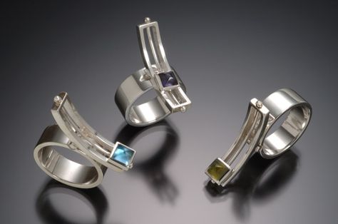 Danielle Miller Jewelry  South Carolina jewelry metal smith, Danielle Miller, truly understands fidgets.  Her contemporary designs are stunning - in looks and in sheer cleverness. Take her sterling silver Mod Rocker rings. There are two motions - the curved rectangle at the top see saws while the stone setting slides freely along the it. Moving Jewelry, Danielle Miller, Rocker Rings, Kinetic Jewelry, Free Jewellery Making Tutorials, Stackable Diamond Rings, Contemporary Ring, Contemporary Jewellery, Contemporary Jewelry