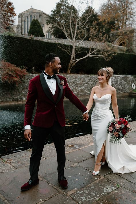 Bride in strapless wedding dress with sparkly Jimmy Choo wedding shoes with the groom in a red velvet suit jacket for their couple portraits Christmas Wedding Picture Ideas, Velvet Groom Suit, Christmas Wedding Pictures, Winter Wedding Suit, Winter Wedding Groom, Groom Winter Wedding, Winter Colour Palette, Engagement Suits, Red Velvet Wedding