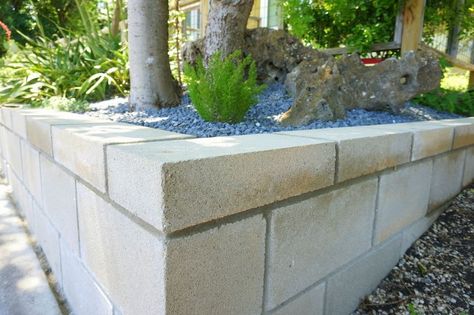 Retaining wall on a slope Cinder Block Retaining Wall, Cinder Block Garden Wall, Concrete Block Retaining Wall, Cinder Blocks Diy, Block Retaining Wall, Retaining Wall Patio, Cinder Block Furniture, Retaining Wall Design, Building A Retaining Wall