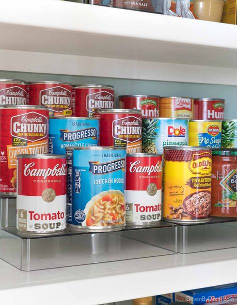 Organized kitchen cabinet with tiered organizer for cans Tiered Organizer, Canned Good Storage, Pantry Can Organization, Cabinet Organization Ideas, Pantry Interior, Free Pantry, Cabinet Storage Solutions, Kitchen Cooktop, Kitchen Cabinet Organization Ideas