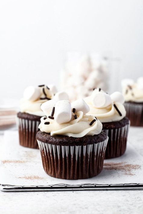 These delicious winter-time Hot Chocolate Cupcakes are perfect for the colder weather! Soft and fluffy with homemade marshmallow frosting and marshmallow fluff make these a must-make dessert. Marshmallow Filling For Cupcakes, Chocolate Marshmallow Fluff Frosting, Cupcakes With Marshmallows On Top, Hot Chocolate Cupcakes With Marshmallow, Cupcakes With Marshmallow Frosting, S’mores Cupcakes With Marshmallow Frosting, Marshmallow Icing, Hot Chocolate Cupcakes, Homemade Marshmallow Fluff