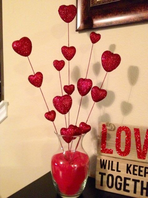 DIY Valentine Decor. Glass vase filled with red sand with heart sticks from Hobby Lobby. Easy and very affordable! Took me less than 10 minutes to make. Valentines Day Hotel, Valentines Day Decorations For Office, Valentine's Day Hotel, Valentines Outdoor Decorations, Aesthetic Valentines Day, Aesthetic Valentines, Saint Valentin Diy, Valentine Centerpieces, Diy Valentine's Day Decorations