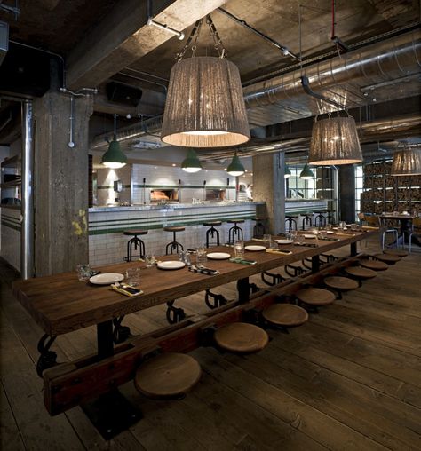 LOVE the oversized pendants over this table.. adds some lightness and flair to the industrial elements Industrial Apartment Decor, Urban Industrial Decor, Decoration Restaurant, Urban Industrial, Tables And Chairs, Exposed Beams, Restaurant Interior, Cafe Design, Commercial Design