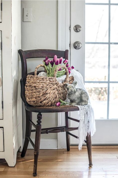 brown antique chair, basket, lace throw, tulips, cement bunny Shabby Chic Spring Decor, Simple Spring Decor Living Room, Indoor Spring Decor, Cottage Easter Decor, Spring Farmhouse Decor Living Room, Spring Vignettes Display Ideas, Spring Cottage Decor, Spring 2023 Decor, Spring 2023 Home Decor