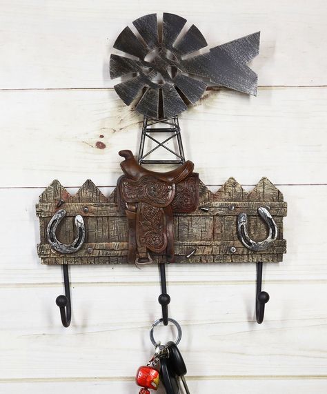 • This Windmill With Horseshoes and Saddle Wall Hanging 3-Peg Hooks Accent is approximately 12.25" tall, 10" long and 2" deep. It is designed to hang on the wall. The wall hooks sculpture weighs about 1.5 pounds. It is recommended to anchor your walls prior to hanging this item. Hanging hardware not included.• This Windmill With Horseshoes and Saddle Wall Hanging 3-Peg Hooks Accent is made of cast iron and polyresin, hand painted and polished individually. Color Tone may vary slightly from pictu Backpack Wall, Antler Rack, Rustic Wall Hooks, Peg Wall, Windmill Decor, Peg Hooks, Coat Hooks On Wall, Gift Catalog, Business Decor