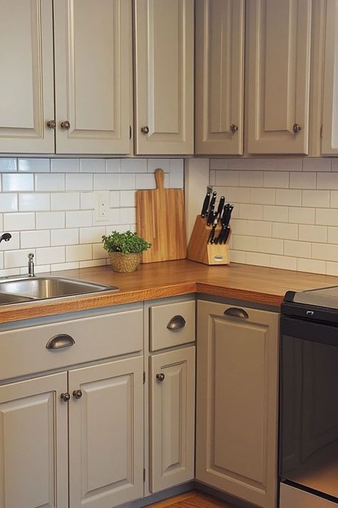 "Elevate your kitchen decor with DIY Painted Cabinets! 🛠️🎨 Perfect for a budget-friendly and stylish update. 🌟✨ #DIYHome #PaintedCabinetsInspo #KitchenDecor" Small Painted Kitchen Cabinets, Diy White Kitchen Cabinets Makeover, Painted Cabinets In Small Kitchen, Repainted Cabinets Kitchen, Townhouse Decorating Kitchen, Painted Wooden Kitchen Cabinets, Old Kitchen Cabinets Painted, Kitchen Remodel Painted Cabinets, How To Reface Kitchen Cabinets Diy