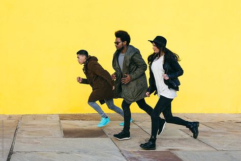 Side View Of Group Of Friends Running In Front Of A Yellow Wall. Download this high-resolution stock photo by BONNINSTUDIO from Stocksy United. Group Running Pose Reference, Running Pose, Running Photography, People Running, Yellow Wall, Poses Reference, Human Poses Reference, Shoe Design, Yellow Walls