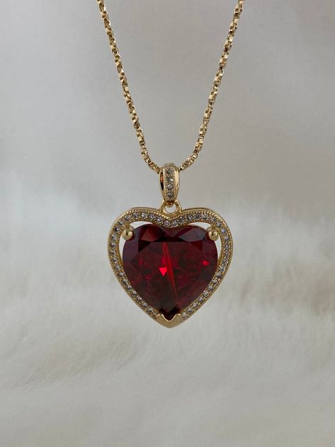 The Ruby Heart Necklace is enchanting! This heart necklace came straight out from a rom-com! It features a large heart-shaped cubic zirconia ruby crystal hugged in a micro pave frame and suspended on a dainty twisted box chain necklace. She takes all other ruby heart necklaces off the scene! Available in 24K gold or rhodium plating over steel Patent plating & sealant technology to ensure durability and long lasting wear Made in Los Angeles, CA | Nickel & Lead Free