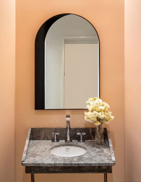 Peach Powder Room, Modern Powder Room Design, Triangular Architecture, Powder Room Design Ideas, Hansgrohe Bathroom, Arched Window Mirror, Peach Powder, Modern Powder Rooms, Modern Powder Room