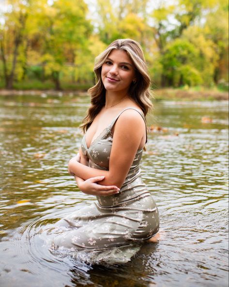 Ella poses in the water during her senior pictures! #SeniorPictureIdeas #HighschoolSeniorPictures Dress In Water Senior Pictures, Senior Pictures River Water, Senior Girl Posing Water, Senior Pictures Water, Female Senior Portraits, Wet Dress, Senior Photoshoot Poses, College Graduation Pictures Poses, Girl In Water