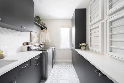 Black and white laundry room features stacked pull-down drying racks fixed to white penny wall tiles over black flat front cabinets donning polished nickel knobs. Gray Washer And Dryer, Black And White Laundry Room, Black And White Laundry, Penny Wall, Stainless Steel Apron Sink, White Laundry Room, Flat Front Cabinets, Black Marble Countertops, White Kitchen Pantry