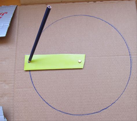 Use the paper fastener to attach one end of the cardboard strip to the center of the cardboard you want to draw on.   To draw a circle, insert the pen into a hole and rotate the strip. Extra Circular Activities, Drawing Circles, How To Draw A Circle, Turn Circles Into Drawings, Diy Compass Circle, How To Use A Compass To Draw Circles, Diy Spoon Mirror, Circumference Of A Circle, Compass Circle