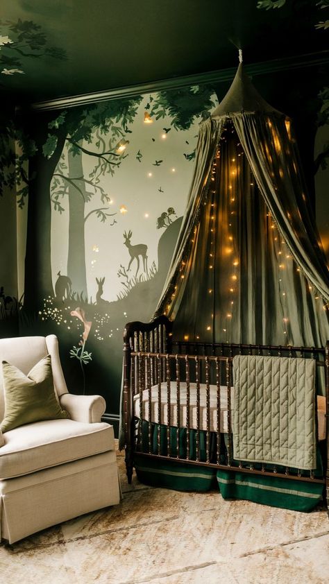 A woodland-inspired baby girl nursery featuring a forest mural with deer and rabbits, a dark wood crib with a green canopy draped in fairy lights, and earthy decor. The cozy space includes a beige rocking chair with a green pillow and a rustic, nature-inspired design. Dark Wood Crib, Woodland Fairy Nursery, Light Green Nursery, Fairy Nursery Theme, Forest Nursery Girl, Green Nursery Girl, Forest Baby Rooms, Forest Nursery Theme, Baby Girl Nursery Ideas