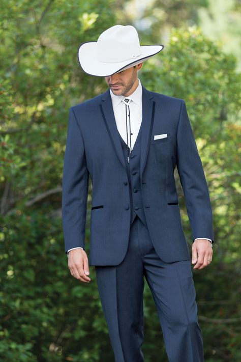 Wear a bolo or string tie to complement the country theme. And don’t forget the cowboy hat and boots! Suit With Western Boots Men, Mens Western Suits Country Weddings, Navy Cowboy Wedding, Men’s Western Suits, Cowboy Outfit Wedding, Men Wedding Outfit Western, Blue Suit With Cowboy Boots, Bolo Tie Tuxedo, Cowboy Formal Wear Men Western Weddings