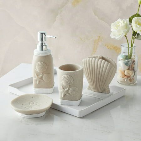 Bring the seashore to your bathroom with bathroom accessory set. This lovely handcrafted resin collection is luxurious, stylish, and helps keep your bathroom decor clean, fresh, and organized. The set includes: A tumbler, lotion/soap dispenser, toothbrush holder and soap dish. Accessory collection is designed with an and Each piece is hand crafted in a durable resin. Easy to wipe clean and made to last a lifetime. This ultra-luxurious collection will surely add contemporary charm to your bathroo Bathroom Beach Theme, Small Coastal Bathroom, Shell Bathroom, 4 Piece Bathroom, Coastal Bathroom Decor, Beach Theme Bathroom, Coastal Bathrooms, Bathroom Accessories Sets, Bath Accessories Set