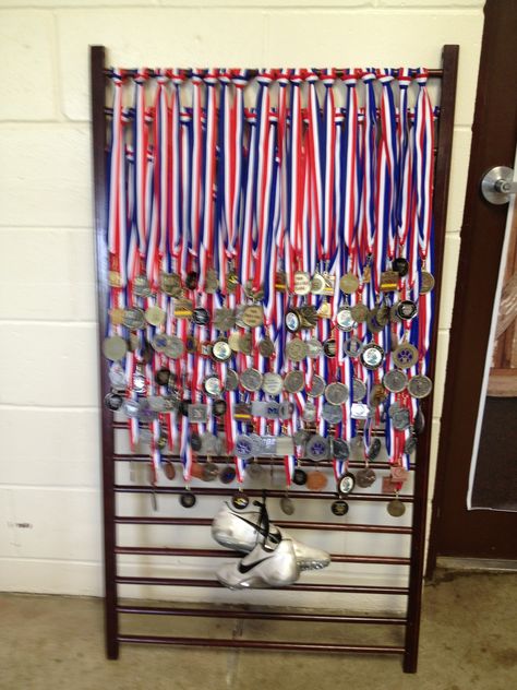 My niece's track medals displayed on a repurposed crib side.                                                                                                                                                                                 More Track Medals, Gymnastics Medal Display, Repurposed Crib, Marathon Ideas, Hanging Medals, Graduation Display, Running Medal Display, Gymnastics Medals, Medal Displays