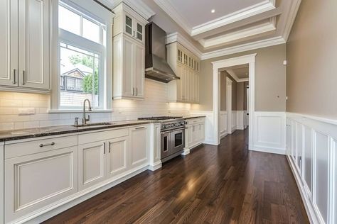 kitchen with white wainscoting and wood floor Kitchen With Waynes Coating, Wainscoting Kitchen Walls, Wainscoting In Kitchen, Kitchen Wainscoting Ideas, Kitchen Wainscoting, Waynes Coating, Wainscoting Kitchen, Two Tone Walls, Cabinets To Go