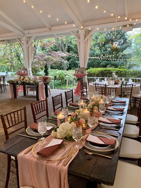 Wood tables in garden with gold dishes Pink Fall Wedding Decorations, Dusty Rose Rustic Wedding Decor, Dusty Rose And Neutral Wedding, Dusty Rose And Pink Wedding, Cinnamon Rose Wedding Table Decor, Fall Wedding Pink Blushes, Dusty Pink And Khaki Wedding, Cinnamon Rose Wedding Reception, Dusty Pink Rustic Wedding Decor