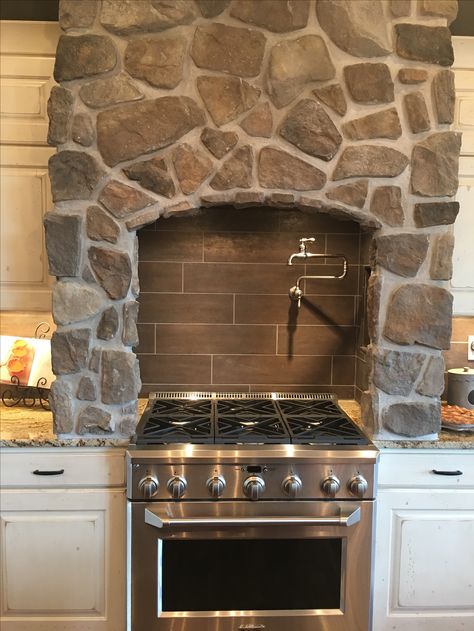 Add a unique touch to your kitchen with a custom stone-wrapped hood vent! This same stone is carried through the kitchen to the adjoining great room fireplace. Definitely a statement piece! Stone Stove Hood, Stone Vent Hoods Kitchen, Stone Vent Hood, Ranch Style Decor, Great Room Fireplace, Hood Vent Cover, Stove Hood, Kitchen Vent Hood, Hood Ideas