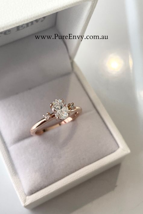 This Rose Gold Diamond Trilogy is a twist on a classic and is perfect for those who love simple, dainty and delicate Engagement Ring designs. A sparkling Oval Diamond claw set in the centre as the feature with Round Brilliant Cut Diamonds delicately complimenting either side. It's whimsical, feminine and simple yet unique. Rose Gold Diamond Engagement Ring, Engagement Ring Designs, Delicate Engagement Ring, Favorite Engagement Rings, Rose Gold Diamond Ring Engagement, Love Simple, Gold Diamond Engagement Ring, Radiant Cut Diamond, Oval Cut Diamond