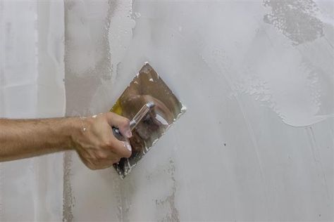 man hand with trowel plastering a wall Diy Stucco Exterior, Decorating Cinder Block Walls, How To Stucco, Cinder Block Garden Wall, Basement Wall Colors, Cinder Blocks Diy, Stucco Fireplace, Concrete Block Walls, Cinder Block Garden