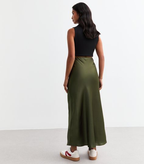 New Look Petite Khaki Satin Midi Skirt. Petite. Comfort and style combined. Shaped with a comfy elasticated waist, this satin midi skirt is a must-have wardrobe staple. Material: lightweight satin Fit: A line Length: midi Colour: khaki green Waist: elasticated Fastening: pull on, elasticated waist Model: 5'4"/162cm and wears UK 8/EU 36/US 4. Green Satin Midi Skirt, Skirt Petite, Satin Midi Skirt, Green Satin, Khaki Green, Wardrobe Staples, New Look, Midi Skirt, Latest Trends