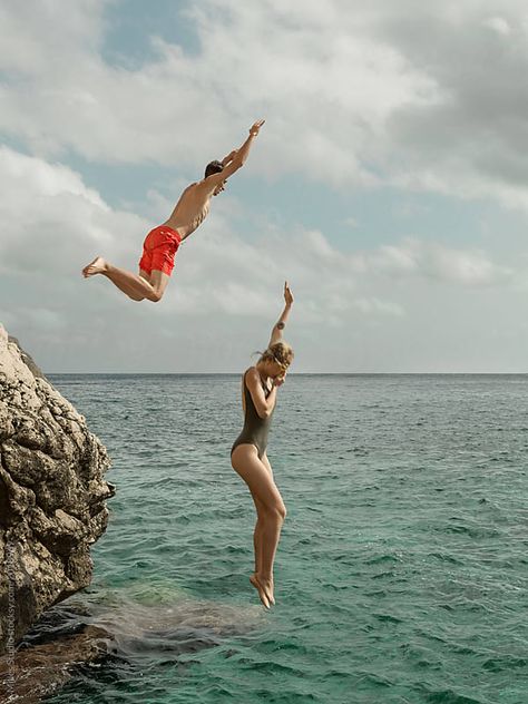 Man and woman jumping into water by Milles Studio for Stocksy United Couple Jumping Into Water, Jumping Into Water Aesthetic, People Jumping Into Water, Man And Woman Aesthetic, Jump Into Water, Jumping People, Jumping Into Water, Person Swimming, Woman Jumping