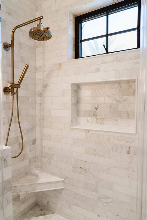 Standing shower with stunning white marble tile, corner bench, shower niche, and brass fixtures. #thedendesigngroup #marbletile #luxurydesign #subwaytileshower #brasshardware #bayareainteriordesign #luxurybathroom Marble Tile Shower, Corner Shower Bench, Marble Shower Tile, Lake Bathroom, Den Design, Shower Repair, Small Full Bathroom, Master Bath And Closet, Subway Tile Showers