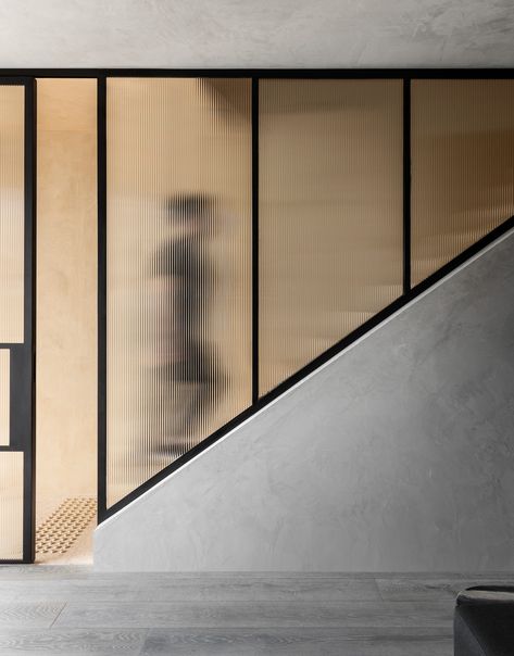 Glass-enclosed staircase with fluted glass panels and black frames in a wellness studio. Stairs Decor Ideas, Enclosed Staircase, Psychology Clinic, Mind Wellness, Stairs Decor, Design Anthology, Venetian Plaster Walls, Australian Interior, Mindful Movement