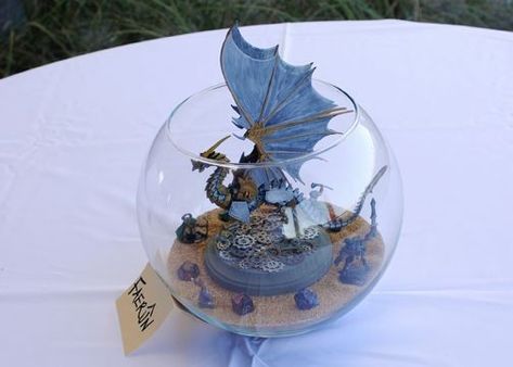 fishbowl centerpieces Dnd Centerpiece, Dnd Wedding, Fishbowl Centerpiece, Medieval Wedding Theme, Wedding Reception Tables Centerpieces, Centrepiece Ideas, Reception Table Centerpieces, Gamer Wedding, Dragon Wedding